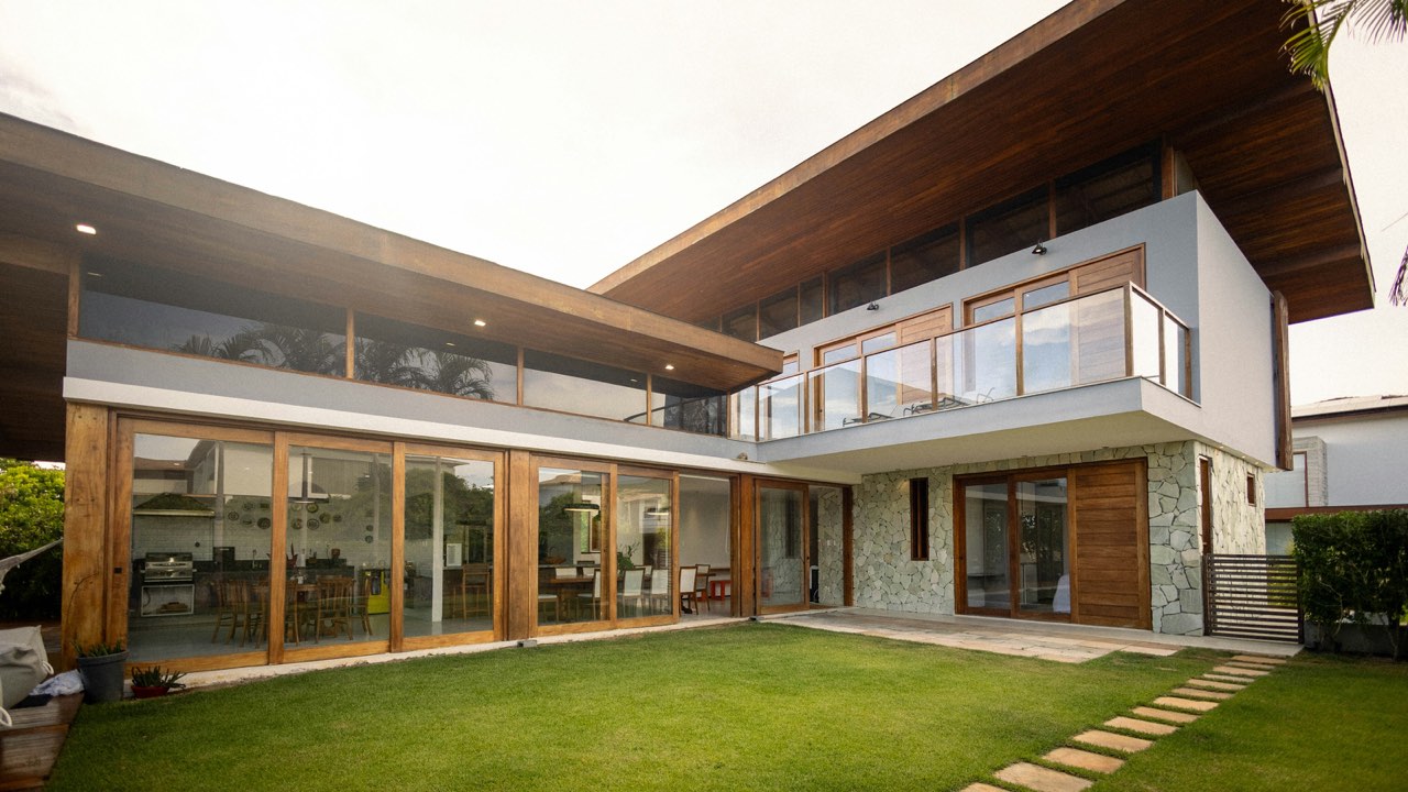 A finished custom home, timber, stone and glass onto the lawn