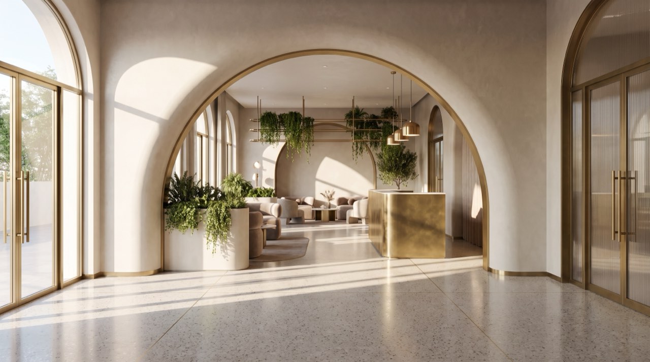 The clinic's arched hallway in morning light, plants on the floor and a reception desk at the far end