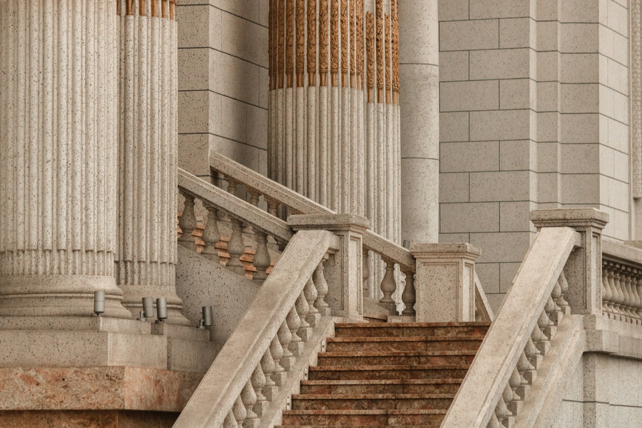 Stone steps rising between the columns of a courthouse