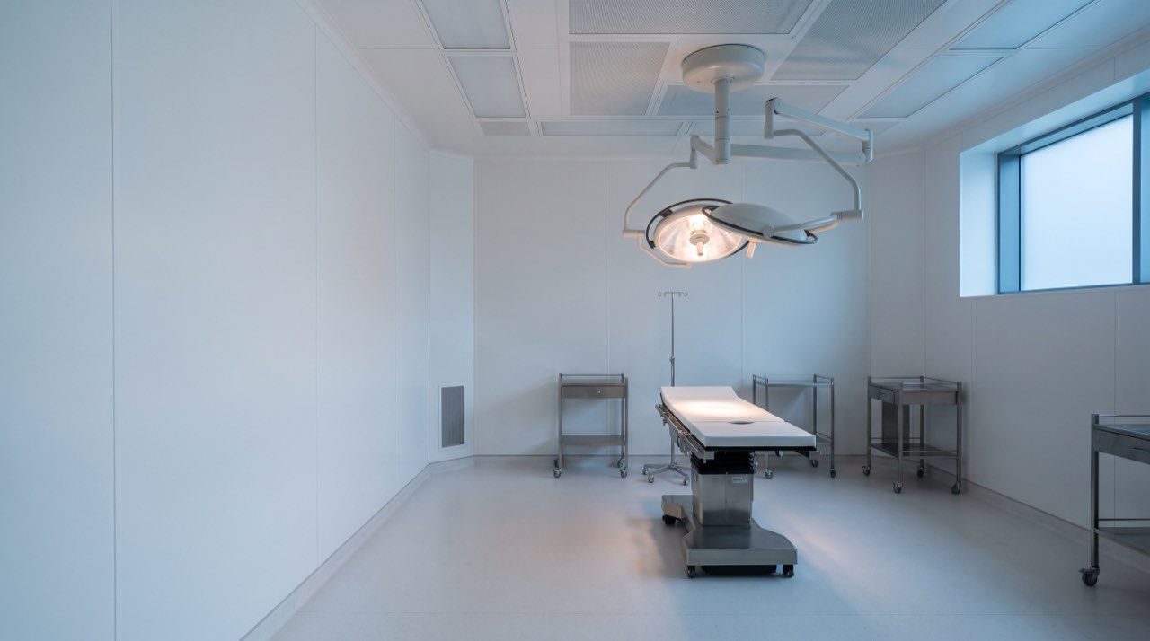 The accredited operating suite, empty and lit, with the table under the lamp