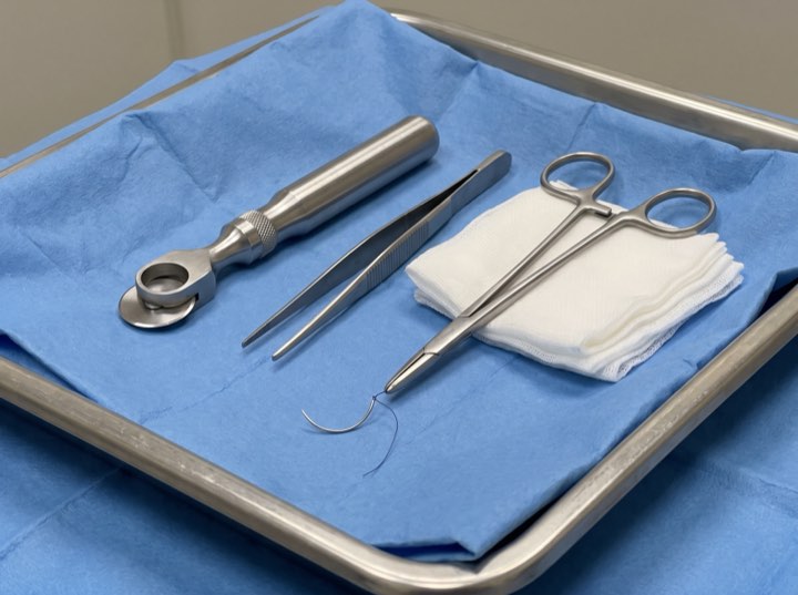 Sterile biopsy instruments on a blue tray