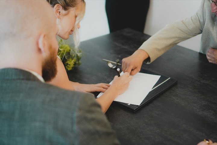 Two people at a desk going through a document together