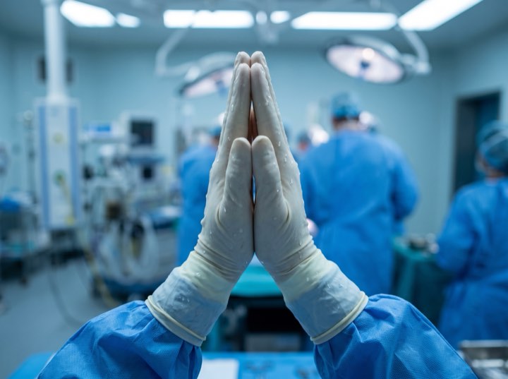 Gloved hands during preparation