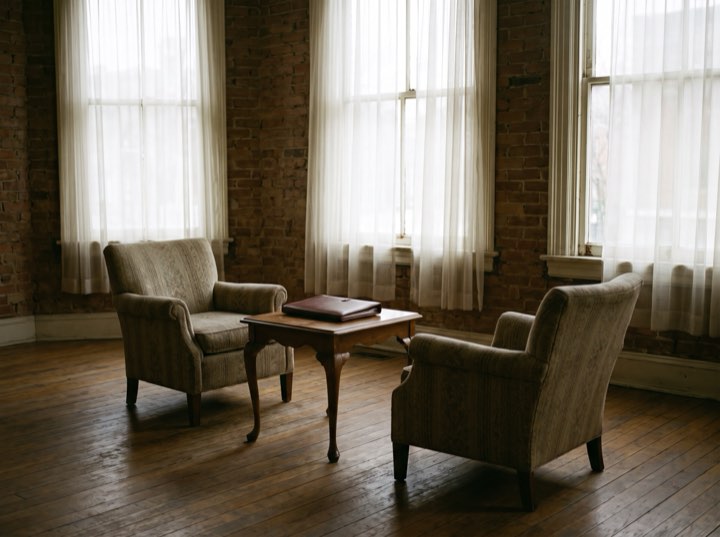 Two armchairs and a low table in the consultation room