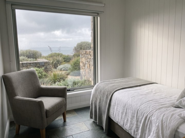 The recovery room, a bed and armchair facing a wide window