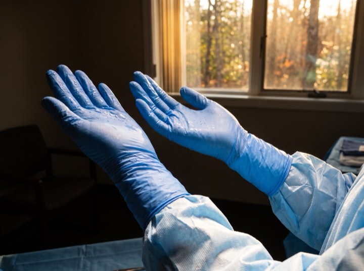 Gloved hands held up after scrubbing in