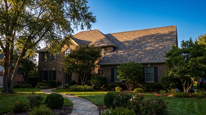 A finished roof on a brick house at golden hour